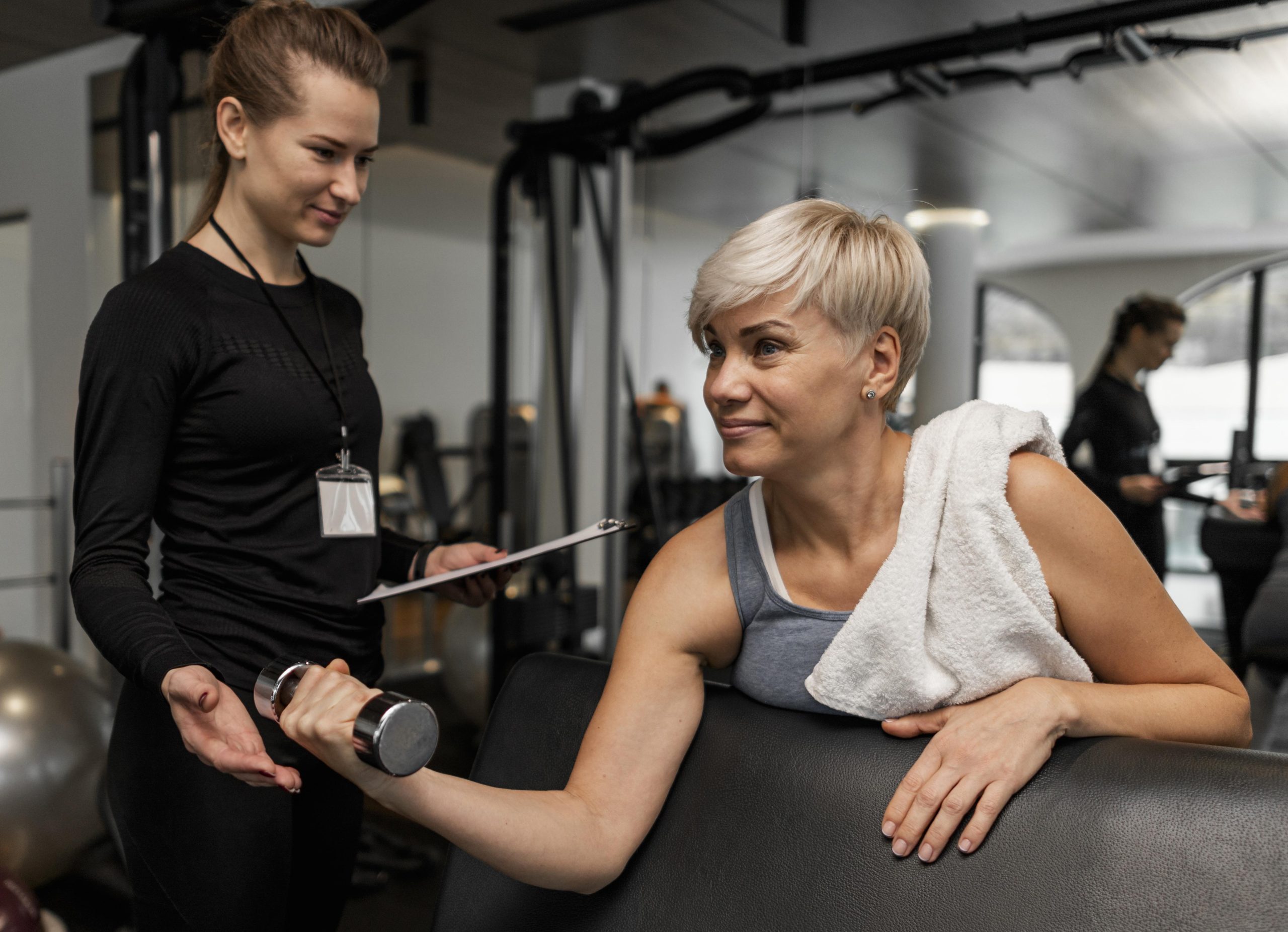female-personal-trainer-her-client-using-dumbbell